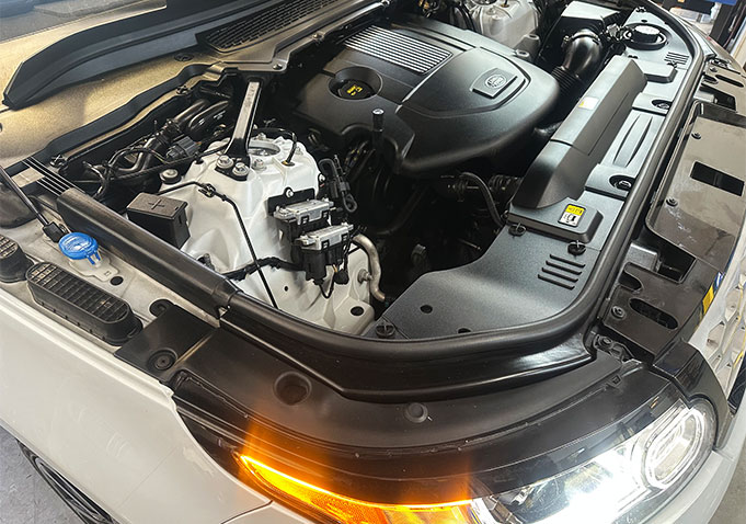 White Land Rover with its engine bay open